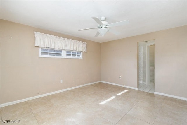 empty room with light tile patterned floors and ceiling fan