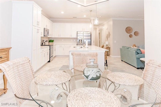 kitchen with white cabinetry, a kitchen island with sink, and stainless steel appliances