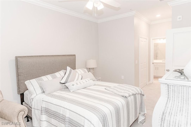 carpeted bedroom featuring ceiling fan, crown molding, and ensuite bath