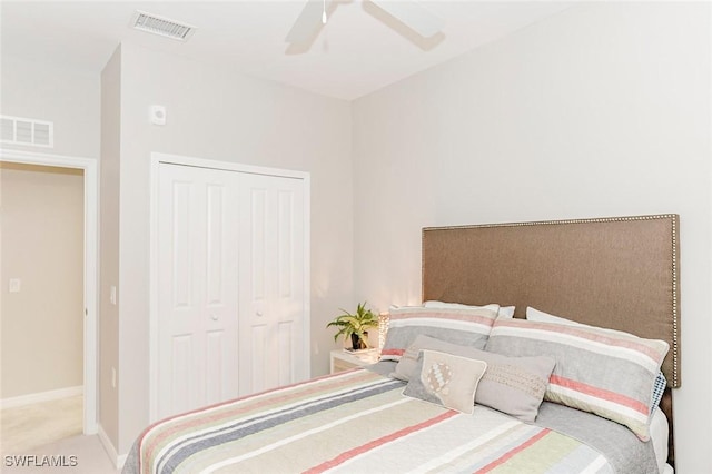 carpeted bedroom with a closet and ceiling fan