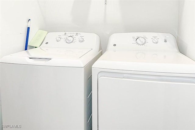 washroom with separate washer and dryer