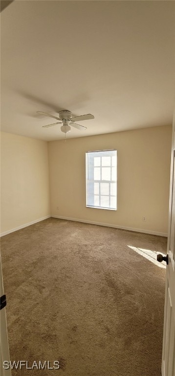 carpeted empty room featuring ceiling fan