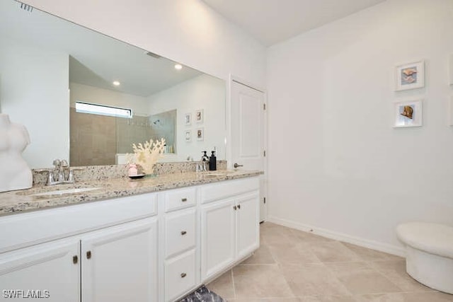 3426 Menores Way, Fort Myers, FL 33905 - bathroom featuring a tile shower, double vanity, and tile patterned flooring