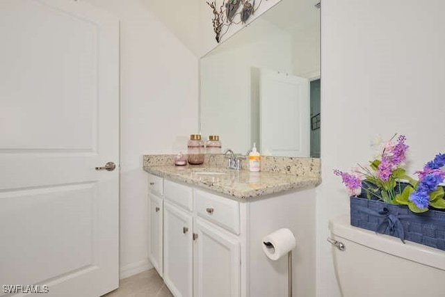 bathroom featuring tile patterned floors, vanity, and toilet