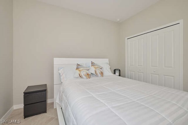 tiled bedroom featuring a closet