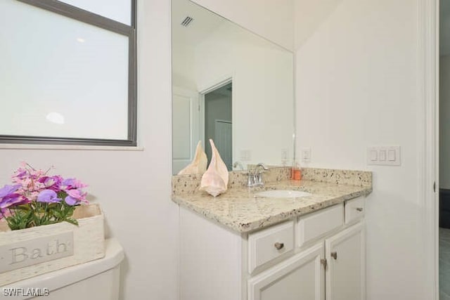 bathroom with vanity and toilet