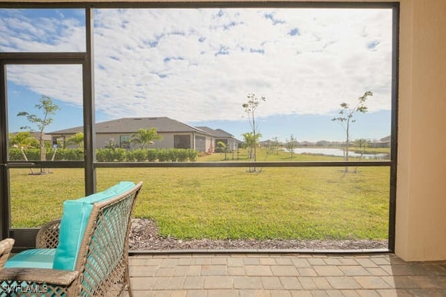 doorway featuring tile patterned flooring and a water view