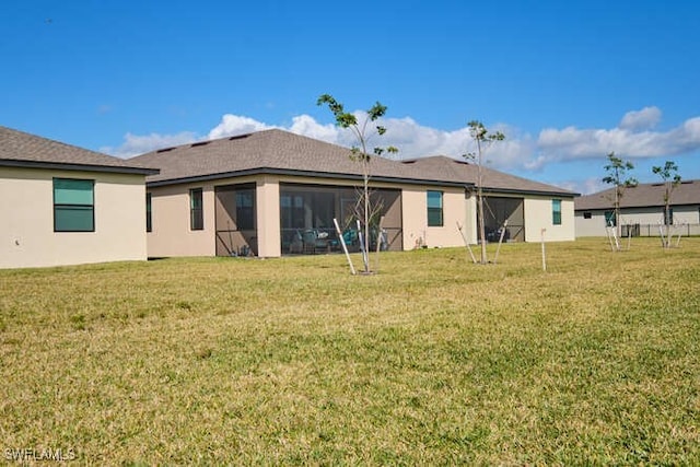 rear view of house with a yard