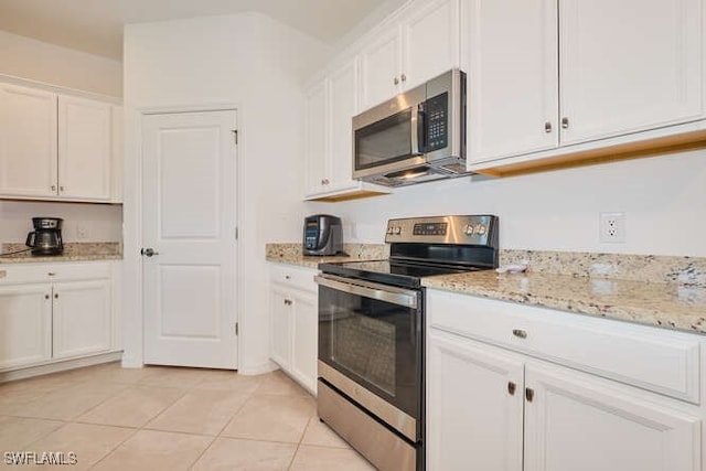 3426 Menores Way, Fort Myers, FL 33905 - kitchen featuring appliances with stainless steel finishes, white cabinetry, light stone countertops, and light tile patterned floors