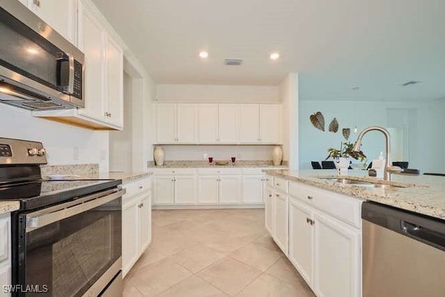 3426 Menores Way, Fort Myers, FL 33905 - kitchen featuring stainless steel appliances, white cabinets, light stone countertops, and recessed lighting