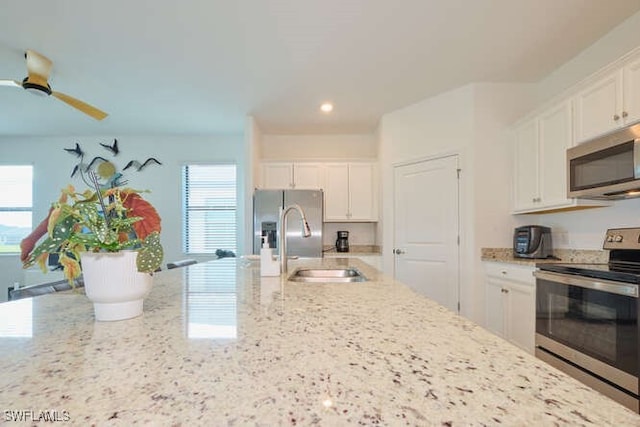 3426 Menores Way, Fort Myers, FL 33905 - kitchen with stainless steel appliances, healthy amount of natural light, white cabinetry, light stone countertops, and recessed lighting