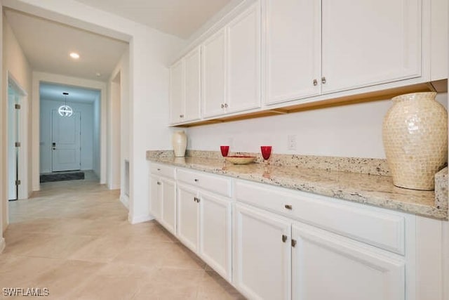 3426 Menores Way, Fort Myers, FL 33905 - kitchen featuring white cabinets, light stone counters, recessed lighting, and light tile patterned flooring