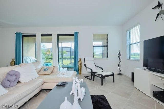 living room featuring a healthy amount of sunlight and light tile patterned floors