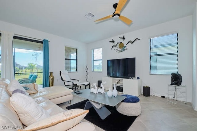 tiled living room featuring ceiling fan