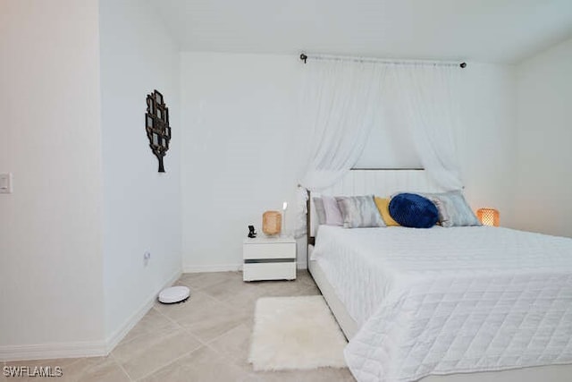 bedroom with light tile patterned flooring