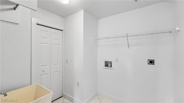 clothes washing area with hookup for an electric dryer, light tile patterned floors, and hookup for a washing machine