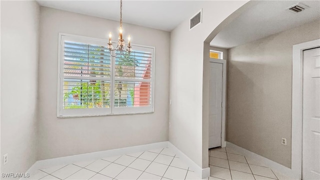 interior space featuring light tile patterned floors and a chandelier