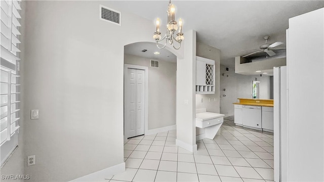 bathroom featuring tile patterned floors and ceiling fan with notable chandelier