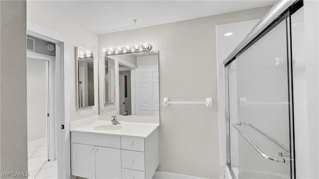 bathroom with tile patterned flooring, a shower, and vanity