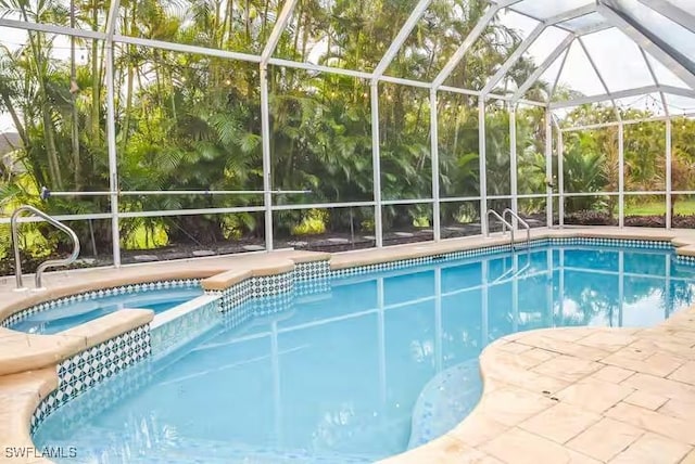 view of swimming pool featuring glass enclosure and an in ground hot tub