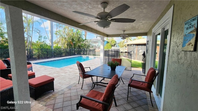 view of pool featuring ceiling fan and a patio area