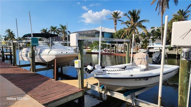 dock area with boat lift and a water view