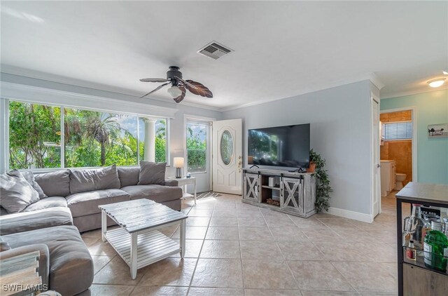 tiled living room with ceiling fan and ornamental molding