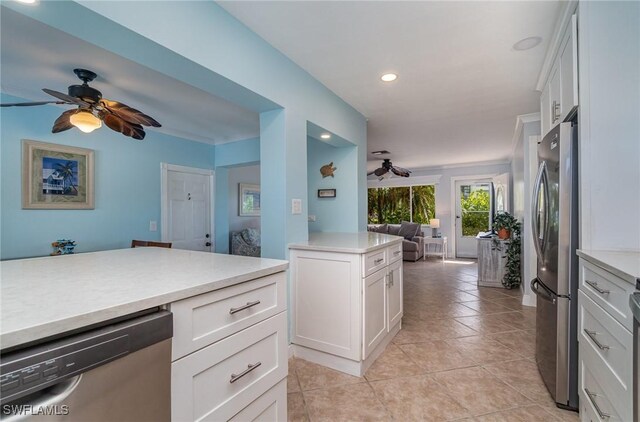 kitchen with ceiling fan, light tile patterned floors, white cabinetry, and appliances with stainless steel finishes