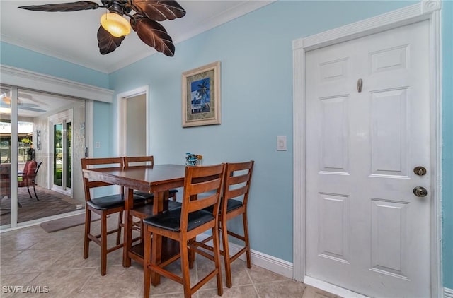 dining area with crown molding, ceiling fan, and light tile patterned flooring