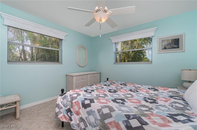 tiled bedroom with multiple windows and ceiling fan