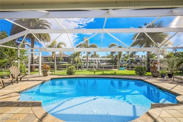 view of pool featuring glass enclosure and a patio