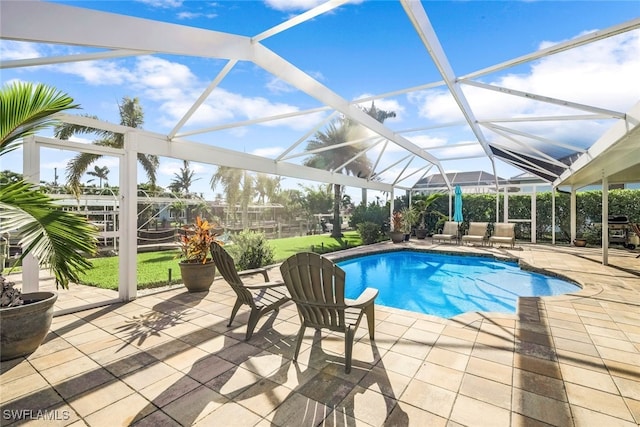 pool with glass enclosure and a patio