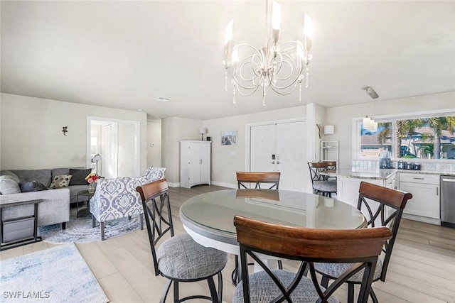 dining space featuring a chandelier and light hardwood / wood-style flooring