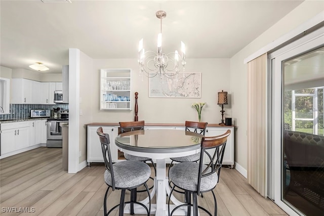 dining space with an inviting chandelier and light wood-type flooring