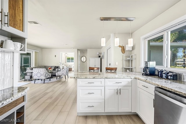 kitchen featuring dishwasher, light wood-type flooring, white cabinetry, and decorative light fixtures