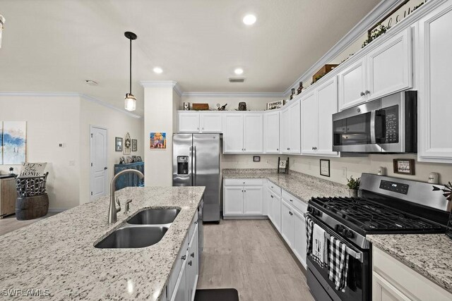 kitchen featuring white cabinetry, sink, stainless steel appliances, crown molding, and light wood-type flooring