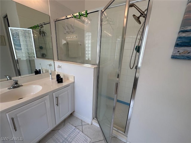 bathroom with tile patterned flooring, vanity, and a shower with door