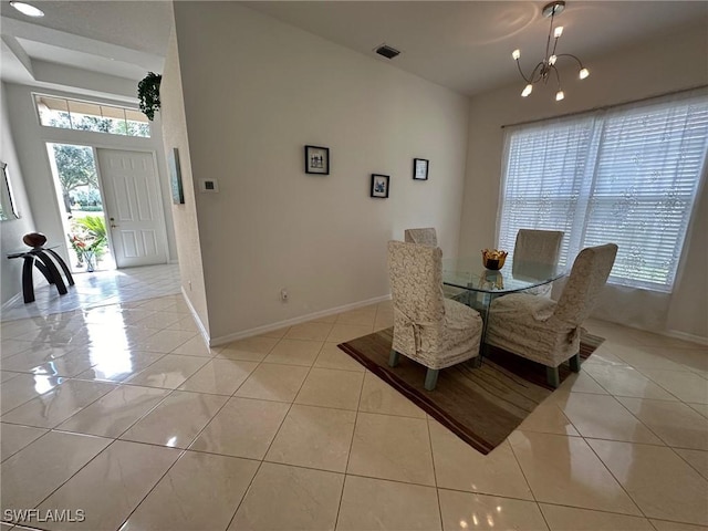 dining room featuring light tile patterned floors, a wealth of natural light, and a chandelier