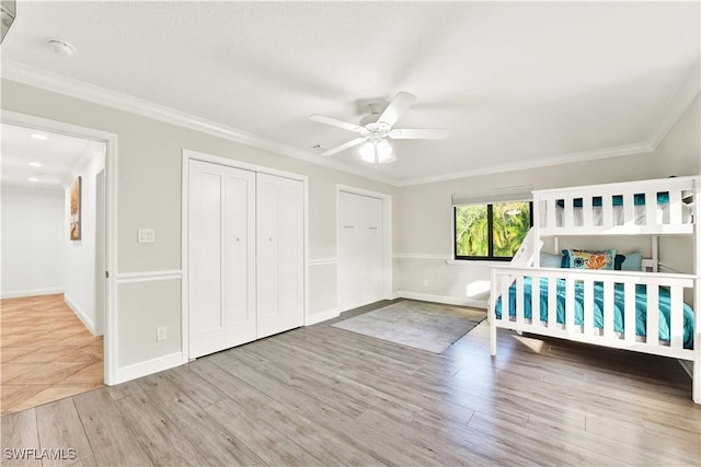 unfurnished bedroom featuring ceiling fan, a closet, ornamental molding, and hardwood / wood-style flooring