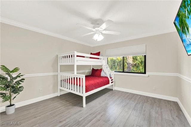 unfurnished bedroom with wood-type flooring, ceiling fan, and crown molding