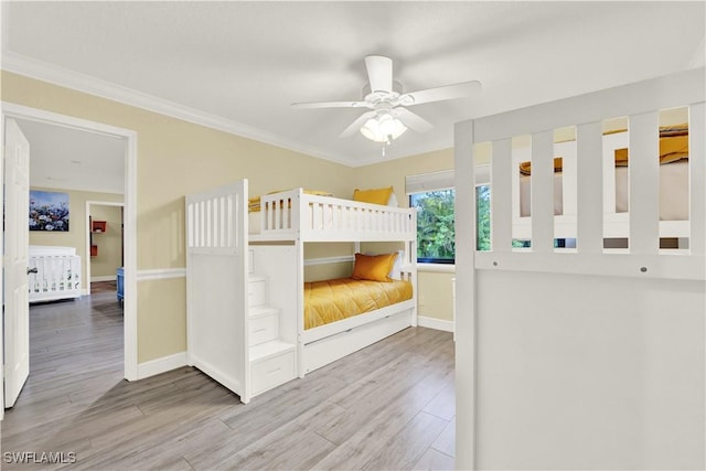 unfurnished bedroom featuring light hardwood / wood-style flooring, ceiling fan, and crown molding