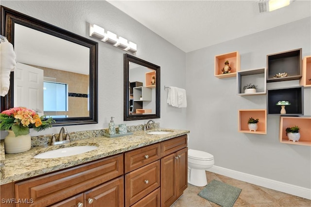 bathroom featuring tile patterned flooring, vanity, and toilet