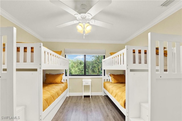 unfurnished bedroom featuring hardwood / wood-style flooring, ceiling fan, and ornamental molding