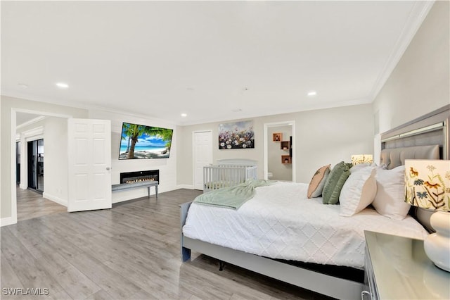 bedroom featuring hardwood / wood-style floors and crown molding