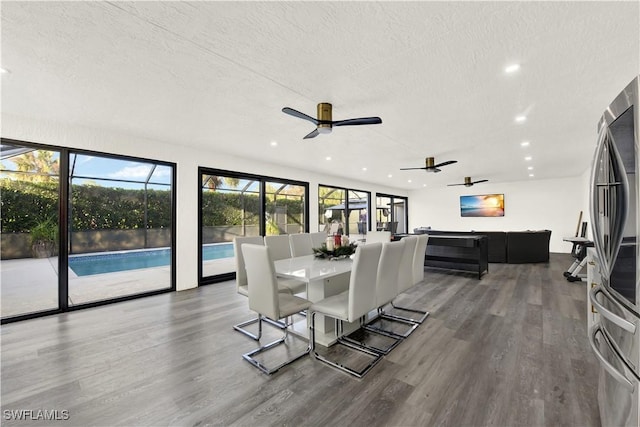 dining room featuring ceiling fan, hardwood / wood-style floors, and a textured ceiling