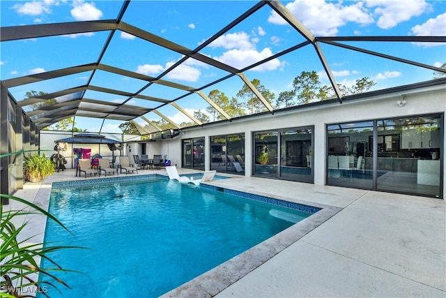 view of pool with a lanai and a patio