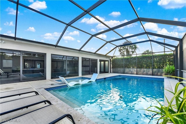 view of pool with a patio area and a lanai