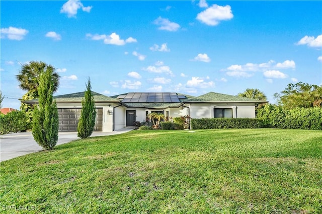 ranch-style house featuring a garage, a front yard, and solar panels