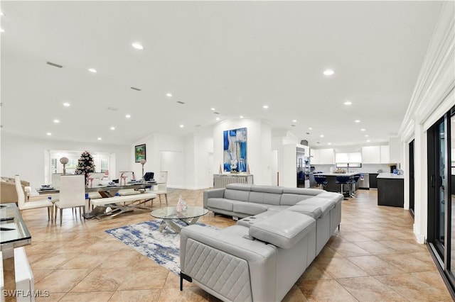 living room featuring crown molding and light tile patterned flooring