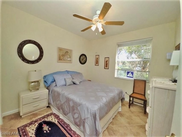 bedroom with ceiling fan and light tile patterned floors